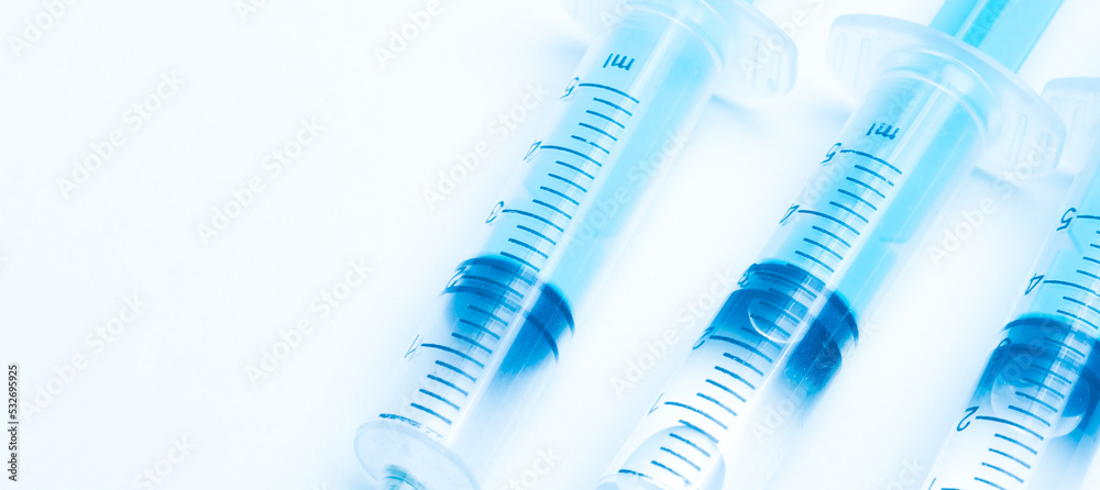 medical disposable syringe with needle for injection in the hospital. medical devices on a white background. virus protection concept medical disposable syringe with needle for injection in the hospital. medical devices on a white background. virus protection concept