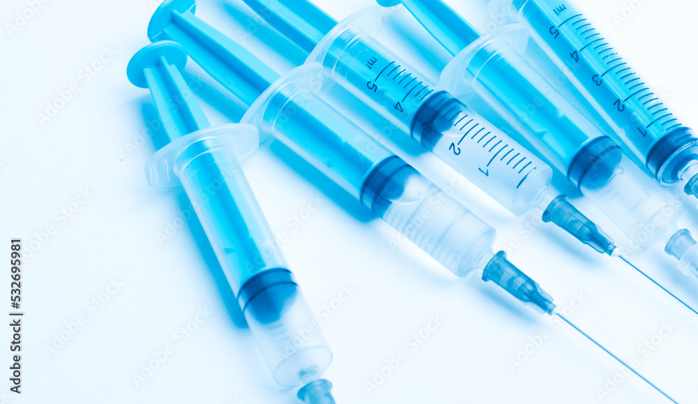 medical disposable syringe with needle for injection in the hospital. medical devices on a white background. virus protection concept medical disposable syringe with needle for injection in the hospital. medical devices on a white background. virus protection concept