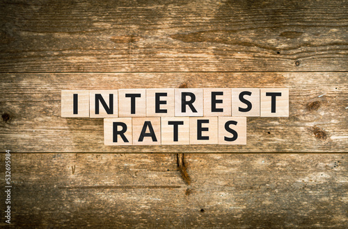 Interest rates on wooden background with calculator, pencil and glasses