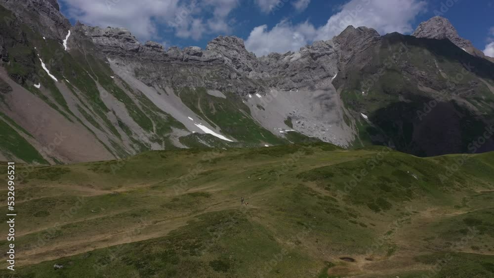 Grassy and green plateau between rugged mountains in the French Alps Grassy and green plateau between rugged mountains in the French Alps