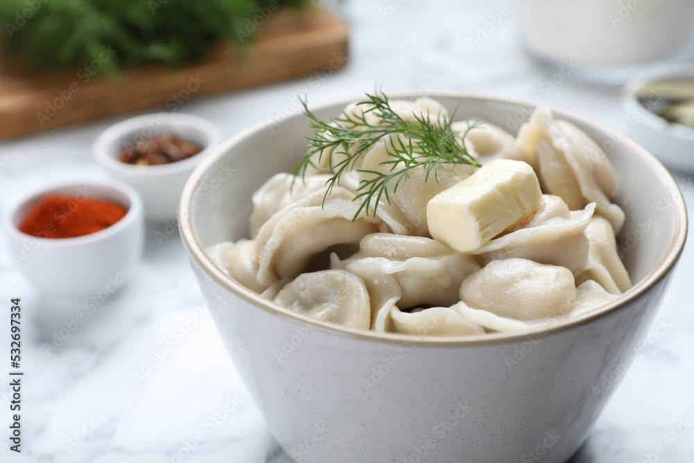 Tasty dumplings in bowl served on white table, closeup Tasty dumplings in bowl served on white table, closeup