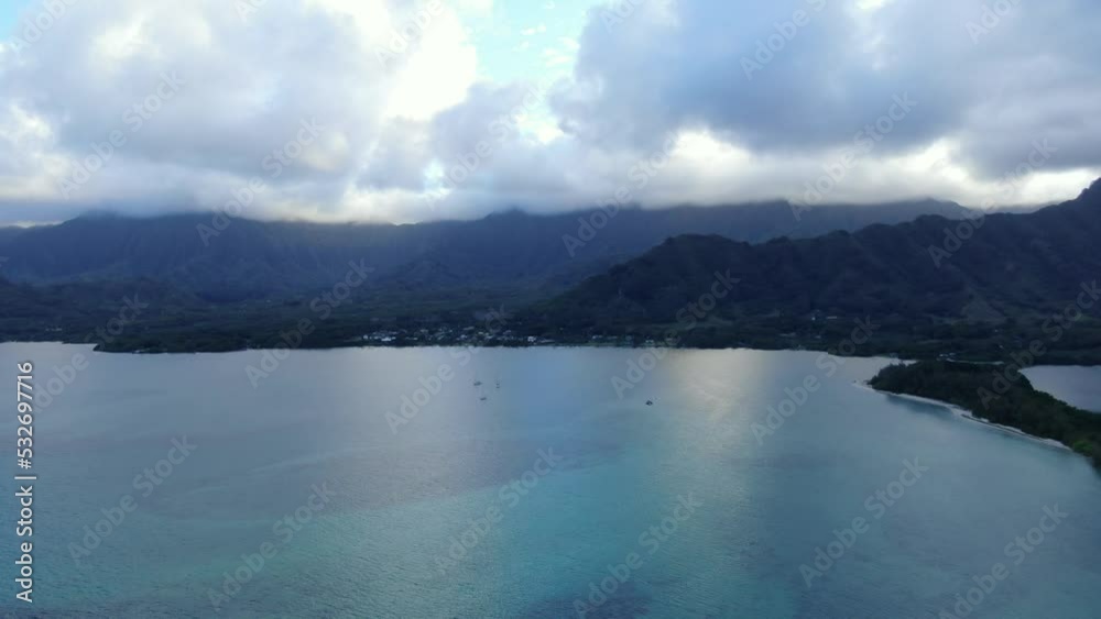 Descending Aerial Shot Of A beautiful Ocean Bay In Hawaii With Small Fishing Boats In The Background Descending Aerial Shot Of A beautiful Ocean Bay In Hawaii With Small Fishing Boats In The Background