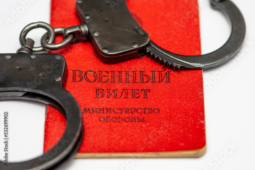 Slika na platnu Russian military ticket has handcuffs on it, white background