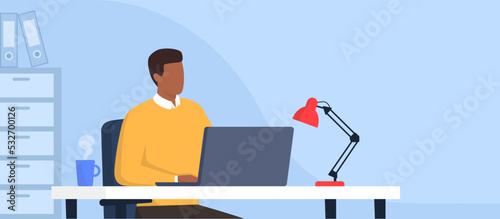 Man sitting at desk and working with a laptop