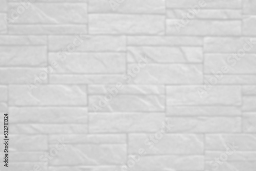 blurry white brick wall texture background for stone tile block painted in grey light color wallpaper modern interior and exterior.