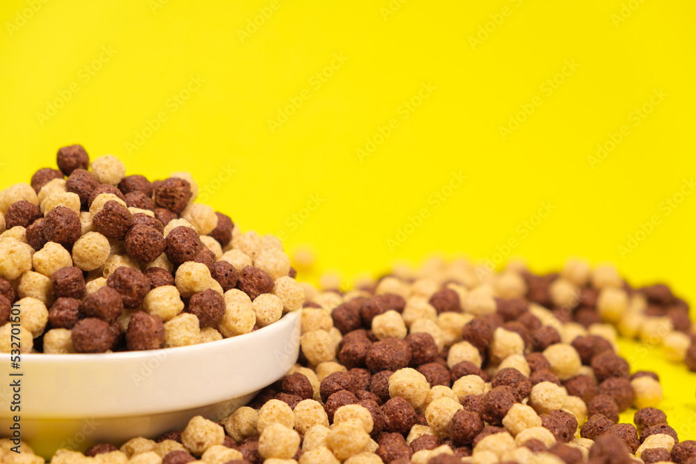 Corn sweet balls on a yellow background. Quick dry breakfasts, side view. Corn sweet balls on a yellow background. Quick dry breakfasts, side view.