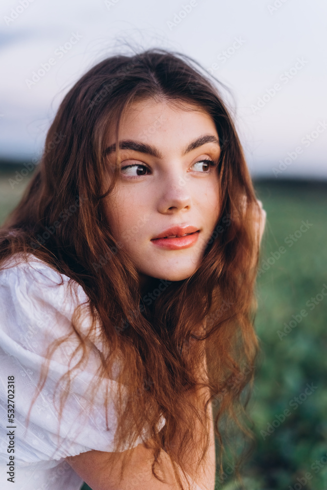 Young girl in white dress in a green meadow. Sensual, pretty, nice woman Young girl in white dress in a green meadow. Sensual, pretty, nice woman
