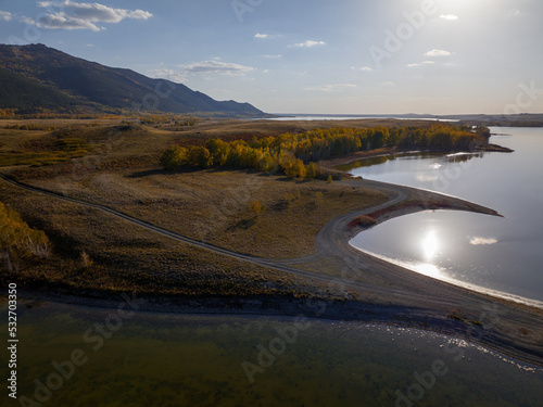 Maibalyk is one of the fourteen lakes located on the territory of the Burabai National Park. The small isthmus divides the lake in two. Aerial top view. photo