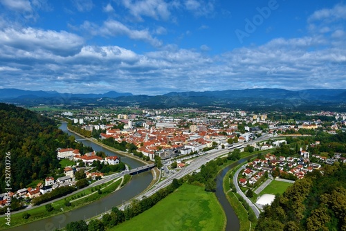 View of the town of Celje next to Savanija river with forest covered hills behind in Stajerska, Slovenia