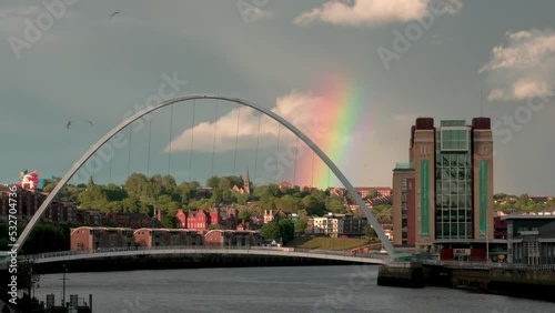Wide shot of Millennium Bridge Gateshead with rainbow over Byker photo