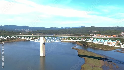 Wallpaper Mural railway bridge over the ulla river, the village, industrial buildings and the forested mountains in the sunny blue sky orizonte, drone shot traveling right turn, Catoira, Galicia, Spain Torontodigital.ca