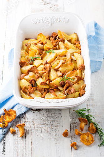Potatoes with Chanterelle Mushrooms and Rosemary on White Wooden Background