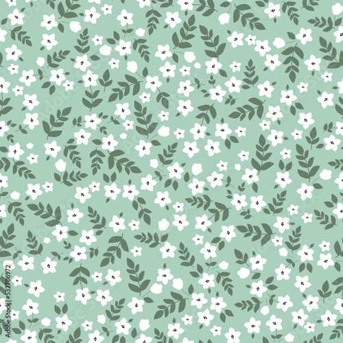 Vintage floral pattern with small white flowers,green leaves on a light green background. Seamless pattern for design and fashion prints.Stock vector illustration.