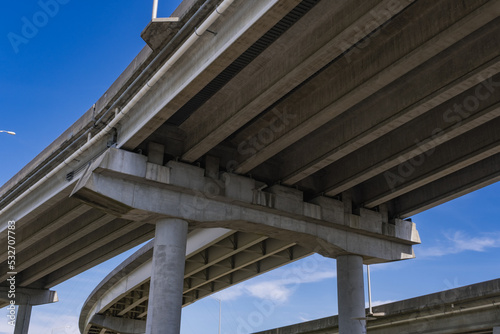 View Underneath a Large Bridge Highway on a Sunny Day with Blue Sky © ToddKuhns