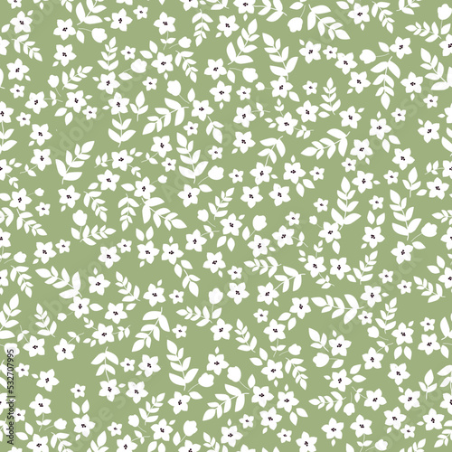 Floral pattern with small white flowers and leaves on green background. Seamless pattern for design and fashion prints.Stock vector illustration.