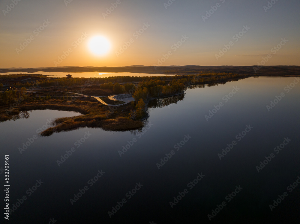 Sunset over Lake Maibalyk in Burabai National Park. Cloudless sky.  Aerial top view.
