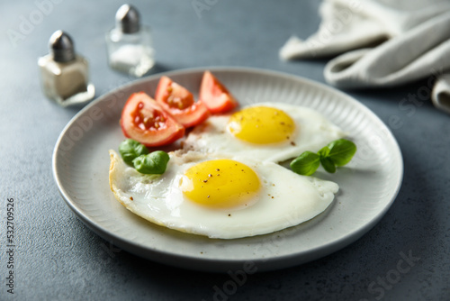 Roasted eggs with tomatoes and basil