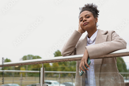portrait of a serious pensive black young woman looking longingly into the distance