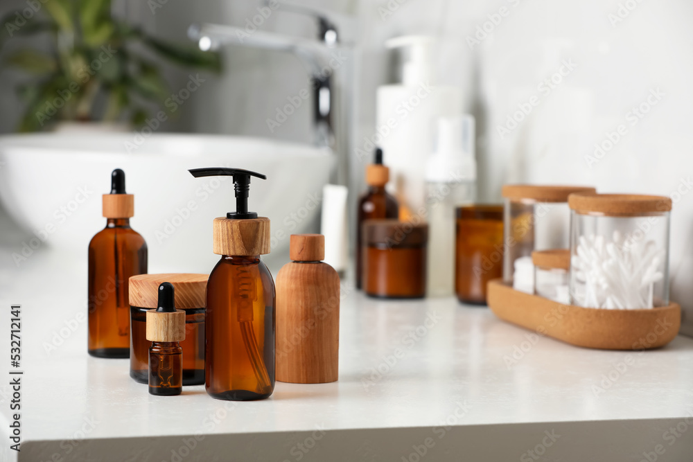 Different personal care products on countertop in bathroom. Space for text Different personal care products on countertop in bathroom. Space for text