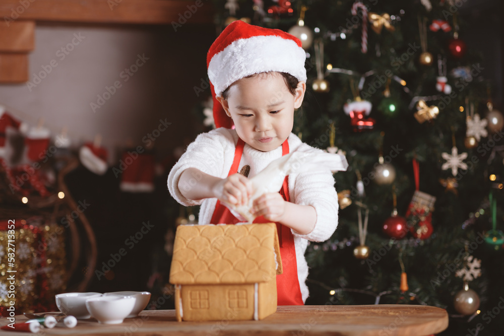 young girl making gingerbread house at home young girl making gingerbread house at home