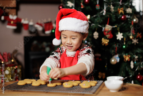 young girl making gingerbread man for celebrating Christmas at home