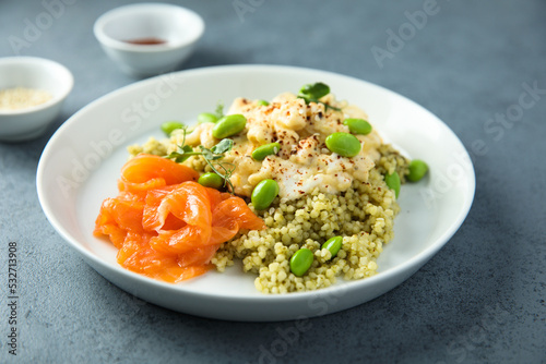 Scrambled eggs with couscous, salmon and beans