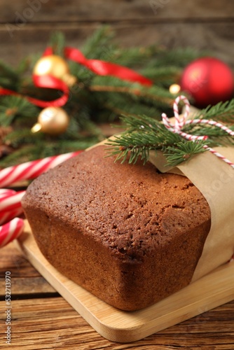 Delicious gingerbread cake and Christmas decor on wooden table