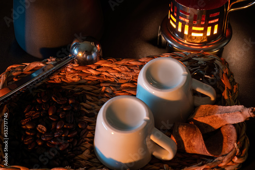 Illuminated coffee cups and beans on a basket