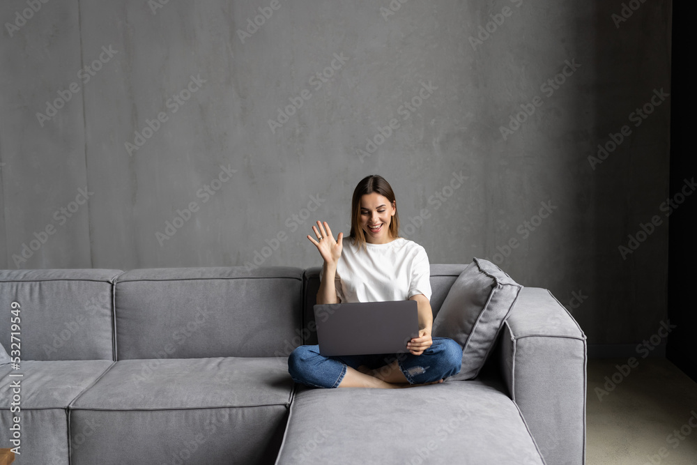 Young happy woman holding video call, gesturing hi to friends, relatives or parents. Attractive female blogger recording new video to followers. Young happy woman holding video call, gesturing hi to friends, relatives or parents. Attractive female blogger recording new video to followers.