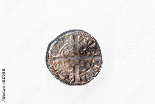 Silver long cross penny English hammered coin of King Henry II of the 14th century dated around 1310- 1314 minted in Canterbury England, reverse cut out and isolated on a white background, stock photo photo