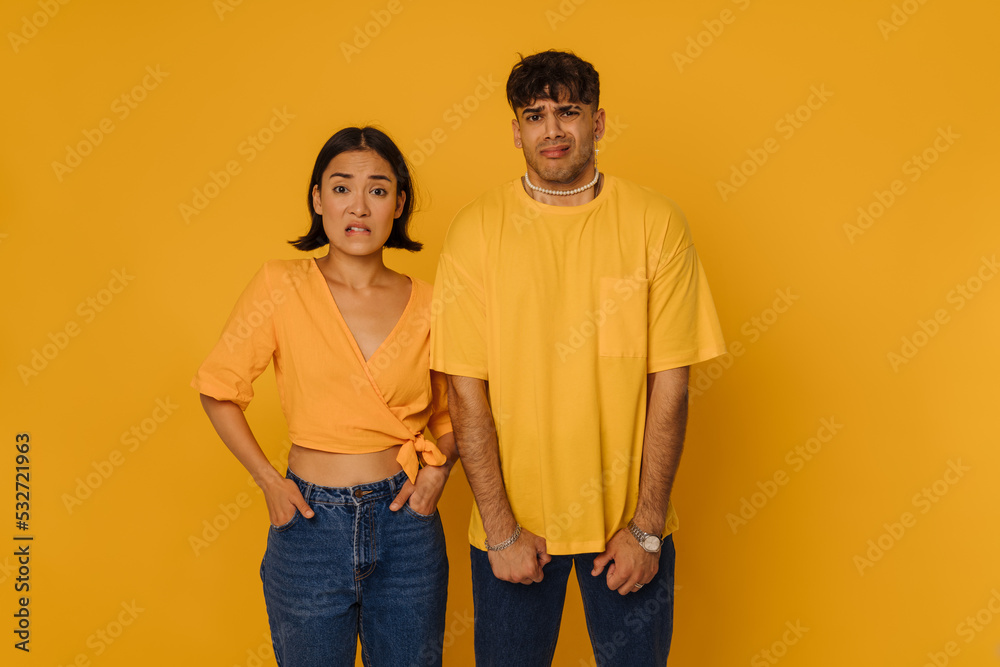 Young beautiful confused asian woman and stylish confused handsome man Young beautiful confused asian woman and stylish confused handsome man