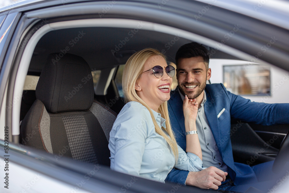 Shot of a cheerful beautiful couple driving in a car together and enjoying in the road trip. Shot of a cheerful beautiful couple driving in a car together and enjoying in the road trip.