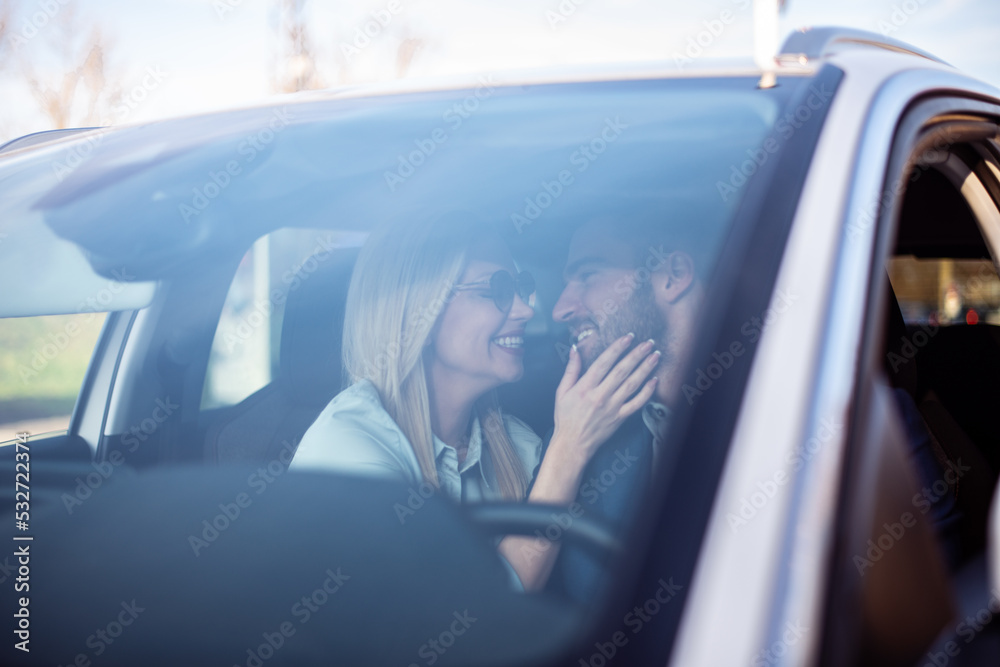 Shot of a cheerful beautiful couple sitting in a car together.
Couple prepairing to kiss