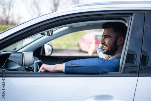 Young business man driving a car