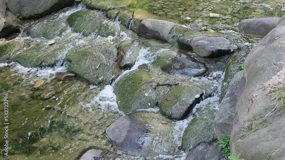 mountain waterfall. water flows down in a torrent. strong current. mountain waterfall. water flows down in a torrent. strong current.