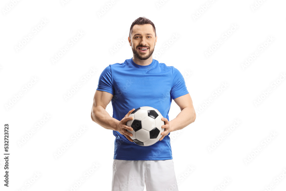 Soccer player holding a ball and looking at camera