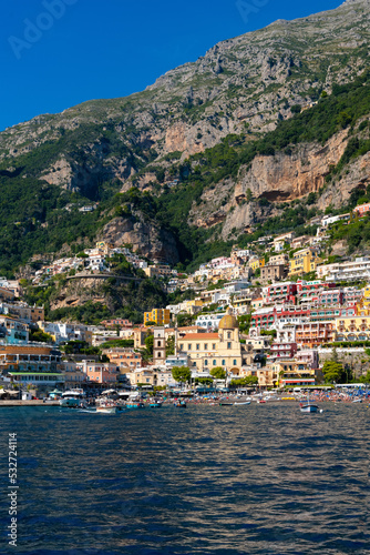 Positano on the famous Amalfi Coast in Campania Italy. Picturesque historic village in world heritage area with colorful houses built on the coastline. Harbour and beech seen from a tourist ferry. © ON-Photography