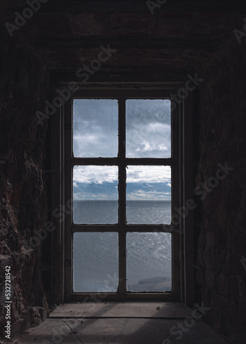 old wooden church window and blue sky in the background