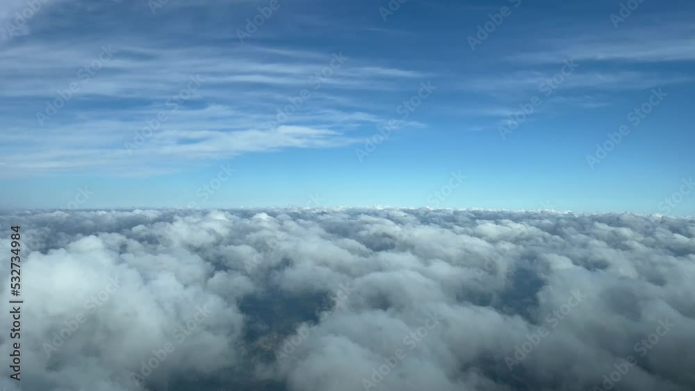 Nice view from a jet cockpit, pilot point of view, overflying a layer of some tiny cumulus. Pilot point of view. 4k 60fps.