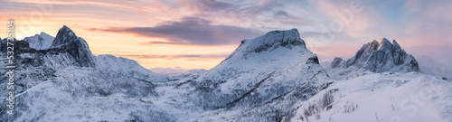 Panorama of sunrise over snowy mountain range with colorful sky in winter on Segla Mount at Senja Island © Mumemories