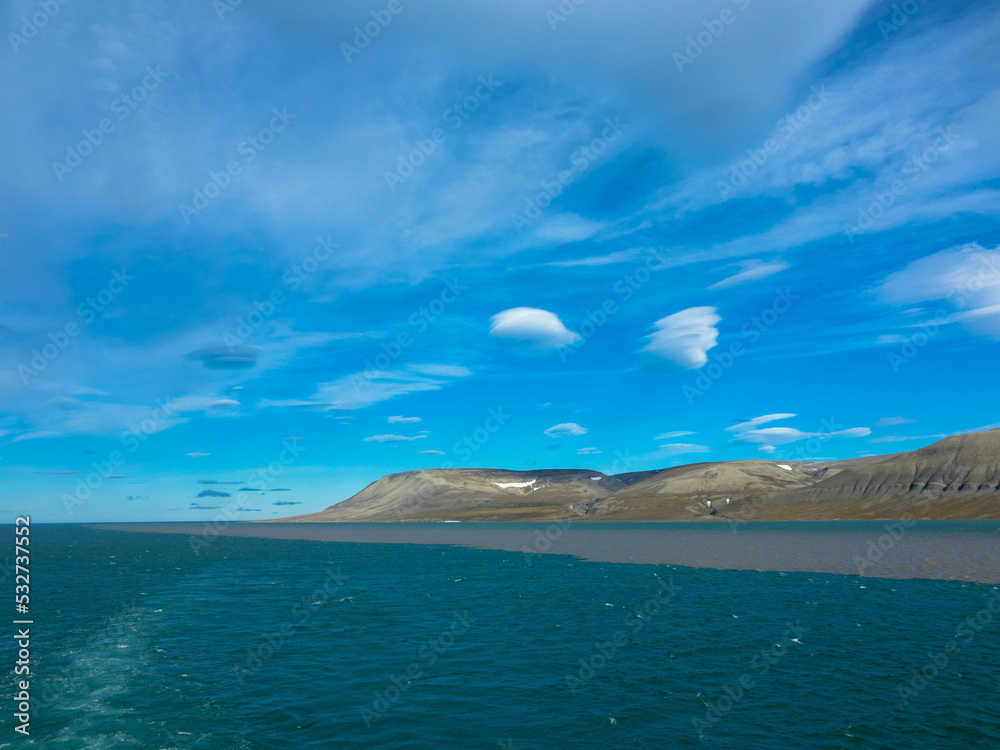 Panoramic view of mountainous snowless arctic landscape. Seen on Barentsoya island. Svalbard, Spitsbergen, Norway. Tourism concept and vacation concept. Panoramic view of mountainous snowless arctic landscape. Seen on Barentsoya island. Svalbard, Spitsbergen, Norway. Tourism concept and vacation concept.