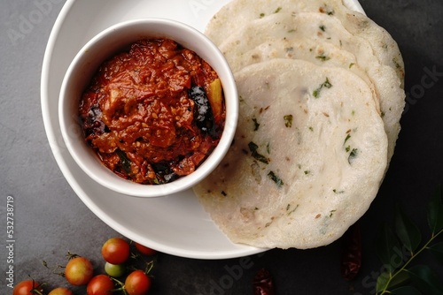 Homemade Tomato pickle Thokku or Chutney served with rice dosa- South Indian breakfast photo