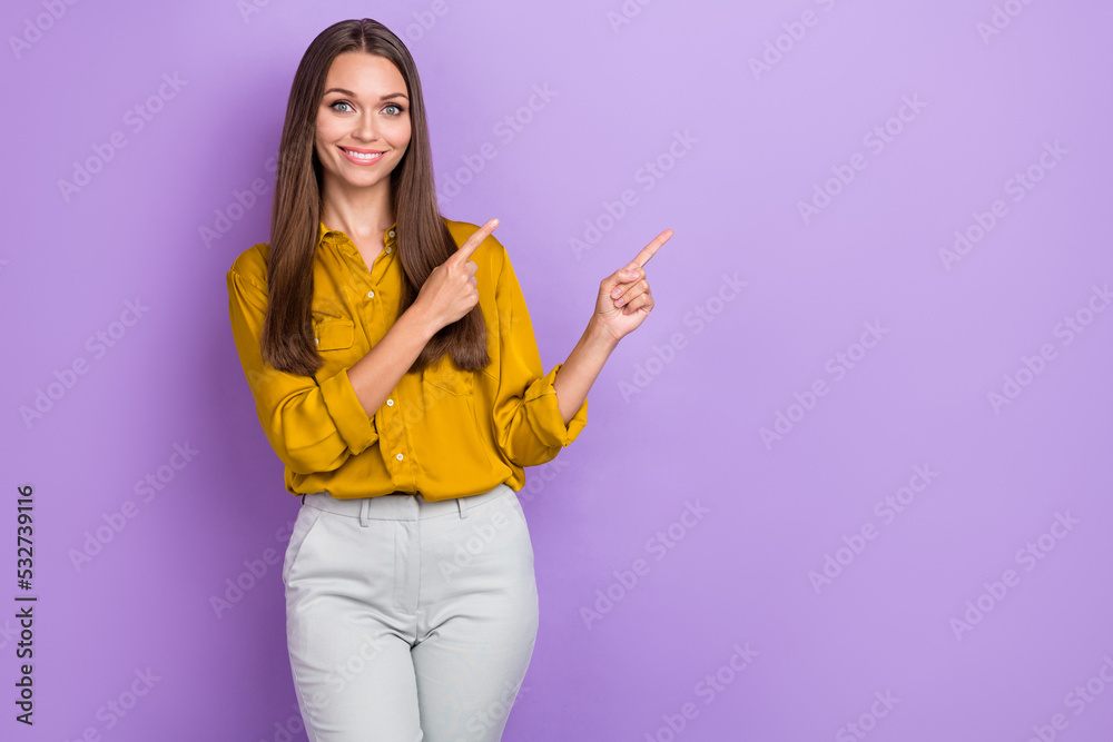 Photo of cheerful pretty lady indicate fingers empty space proposition isolated on violet color background Photo of cheerful pretty lady indicate fingers empty space proposition isolated on violet color background
