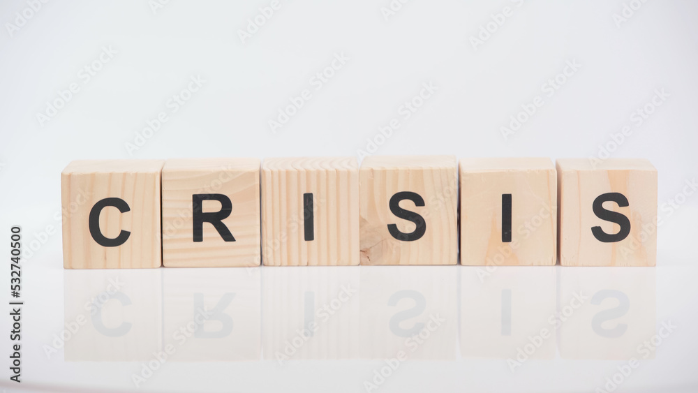 wooden cubes with crisis lettering on white background. wooden cubes with crisis lettering on white background.