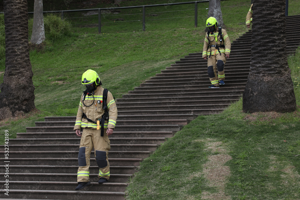Fototapeta premium Fire fighters do fitness training in full equipment at First Fleet steps in the Royal Botanic Garden, Sydney, Australia.