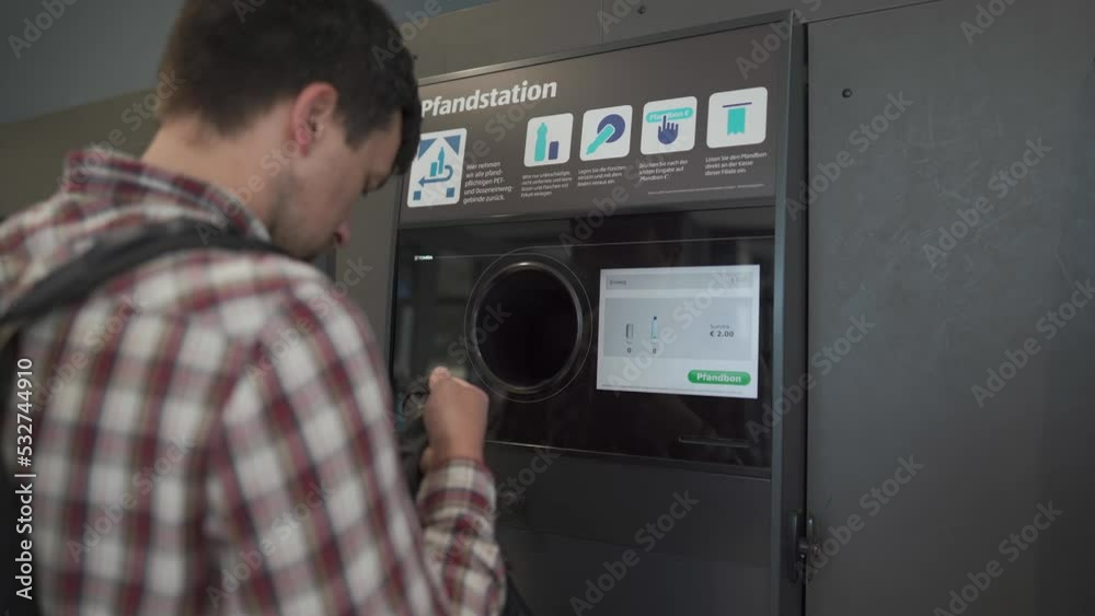 Man recycling plastic bottle at automatic machine collector in exchange for money. Plastic