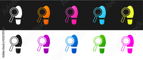 Set Magnifying glass with footsteps icon isolated on black and white background. Detective is investigating. To follow in the footsteps. Vector