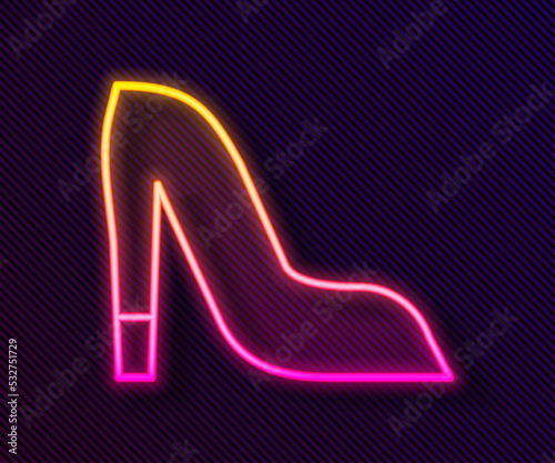 Glowing neon line Woman shoe with high heel icon isolated on black background. Vector