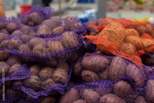 Collect the raw potatoes in a burlap (mesh) on the store counter.