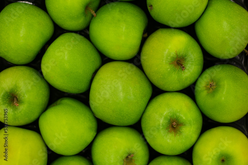 A lot of green apples as a background, pattern, texture.